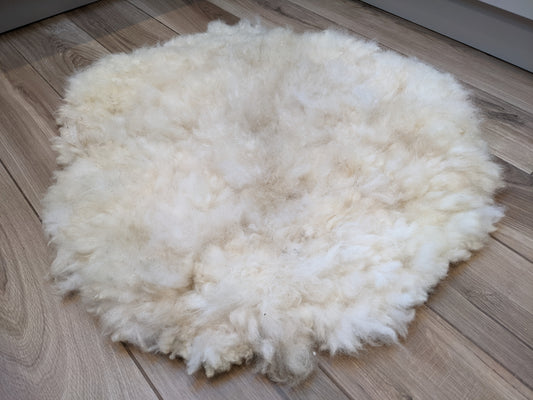 Medium circular cream rug