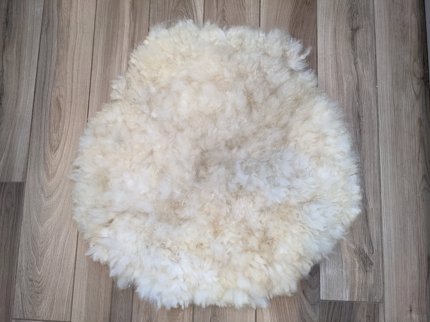 Medium circular cream rug